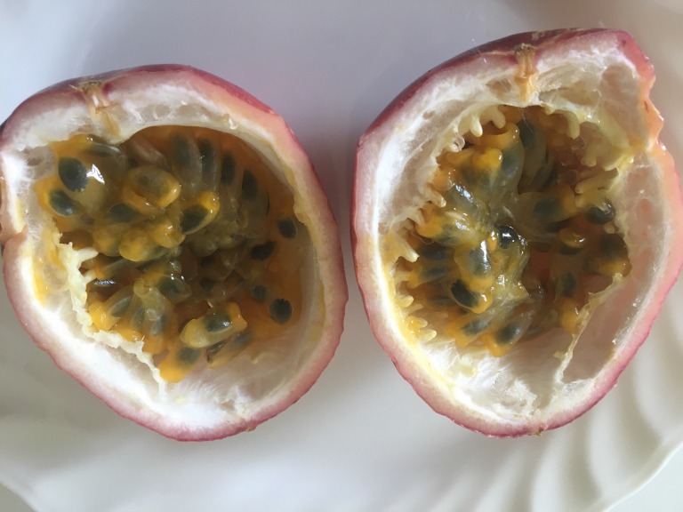 Light red passion fruit cut in half